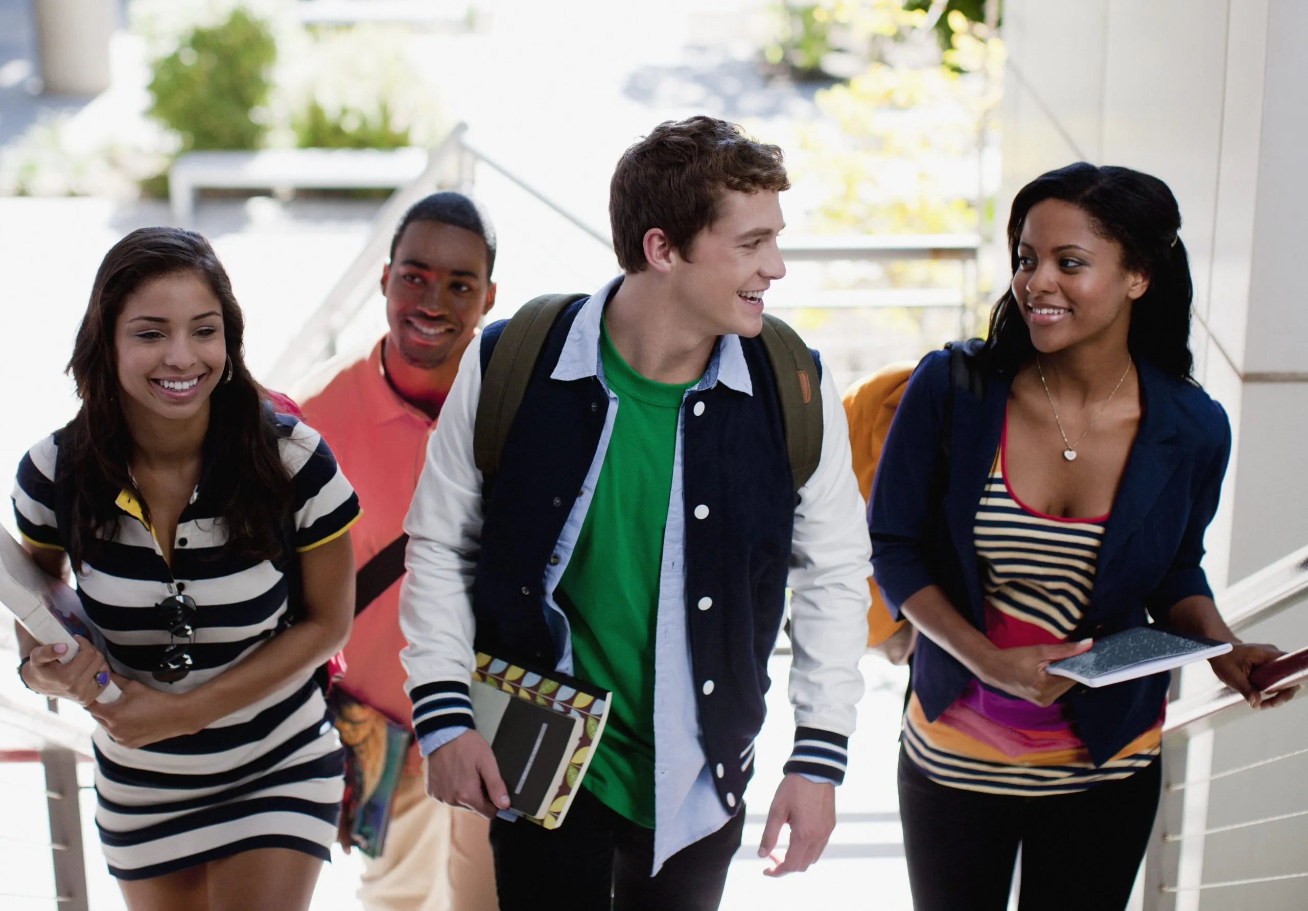 Group of 4 students walking up stairs