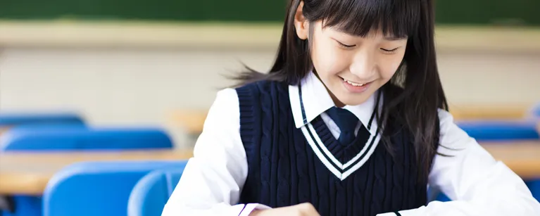 student writing at desk