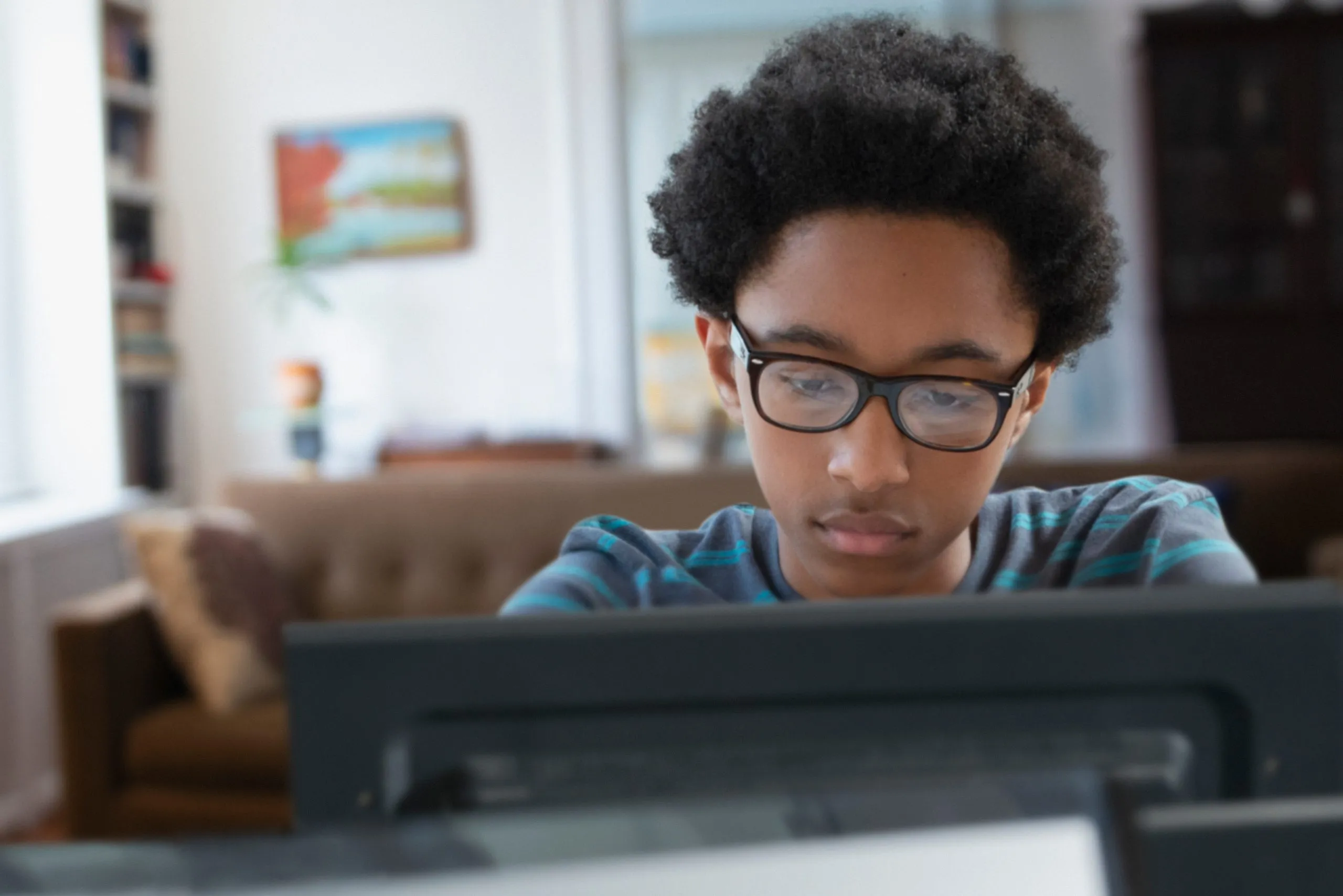 Teenager boy having online classes at home