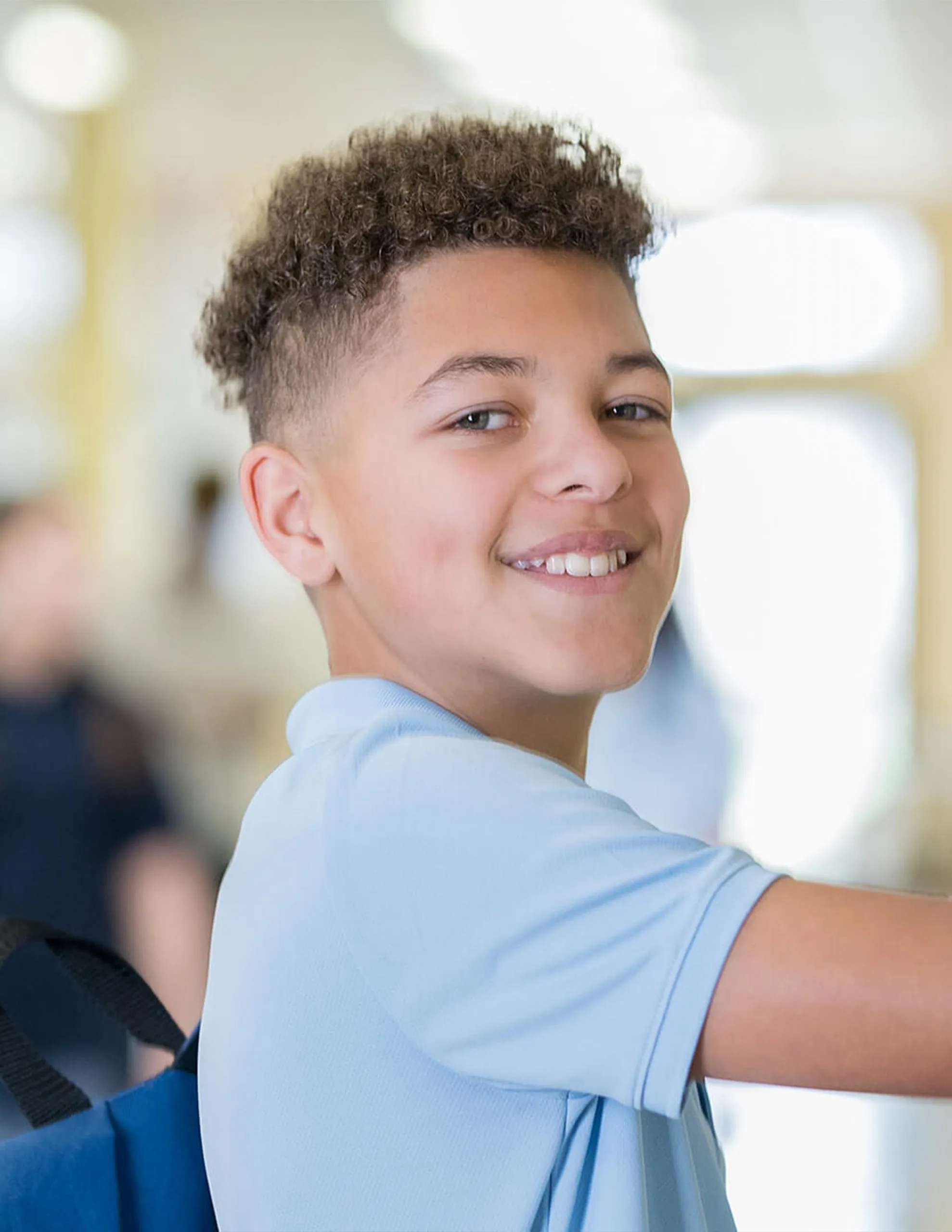 student in front of locker