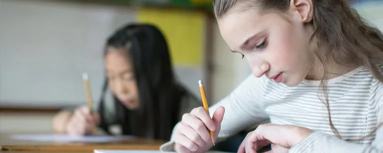 students writing at their desks