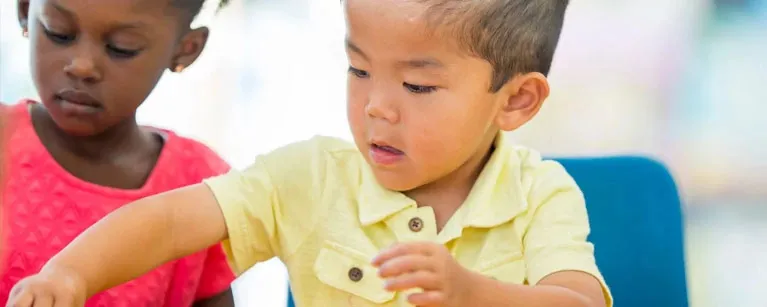 preschool kid doing an activity at their desk