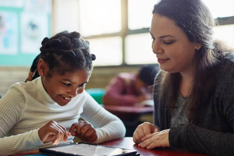 Teacher and student using Star Phonics on a computer