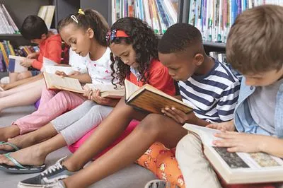 A group of students reading books side-by-side