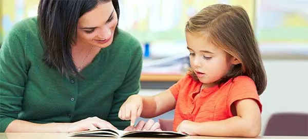 student and teacher reading