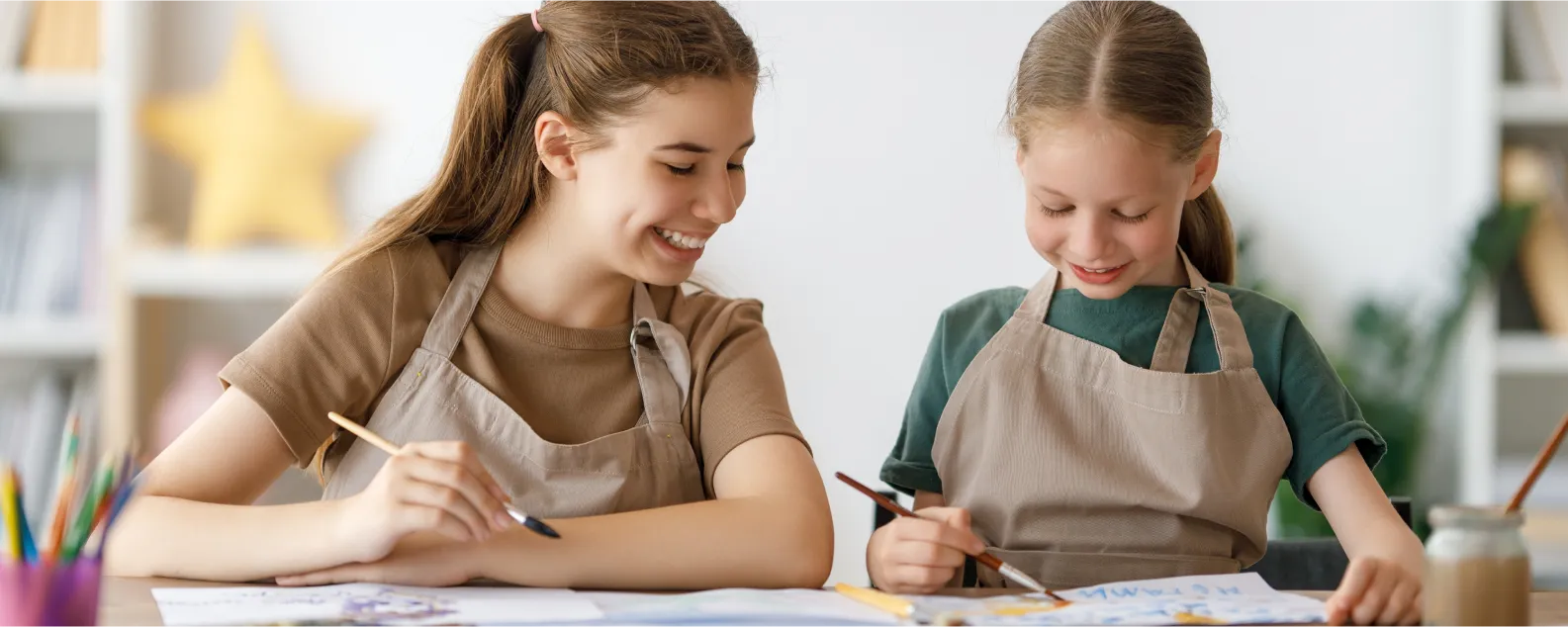 teacher helping student with art project