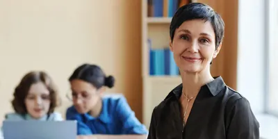 A female teacher looking at the camera