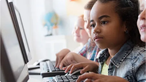 children looking at computer screens