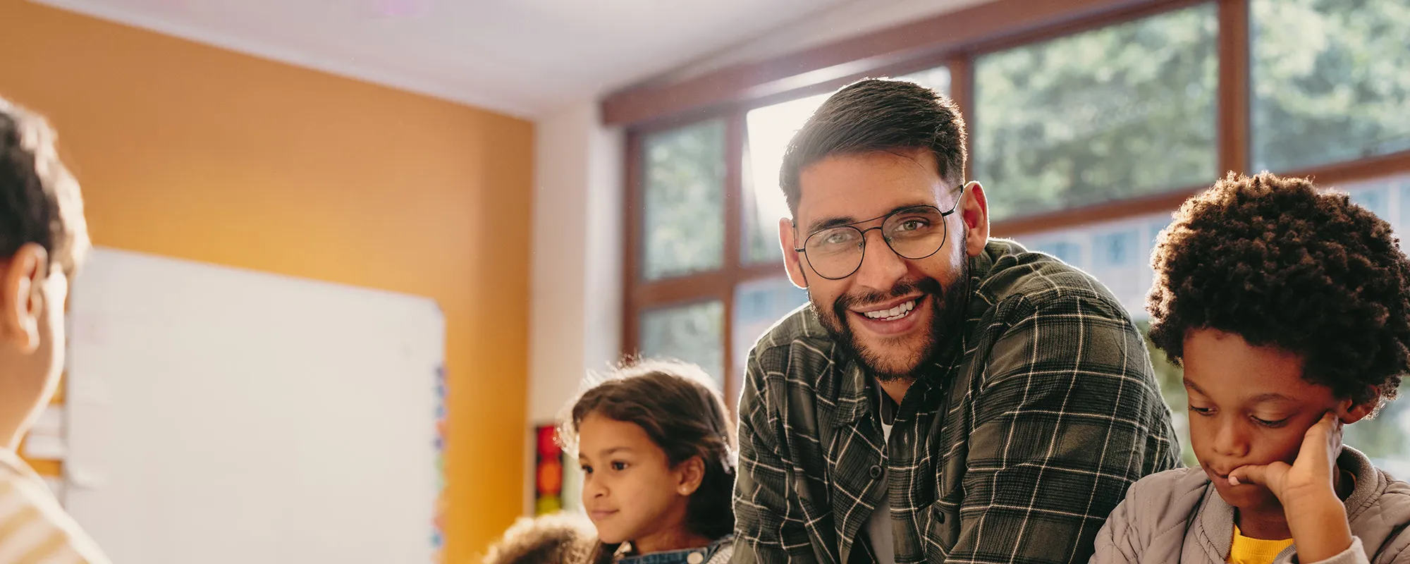 A male teacher in a classroom with his students