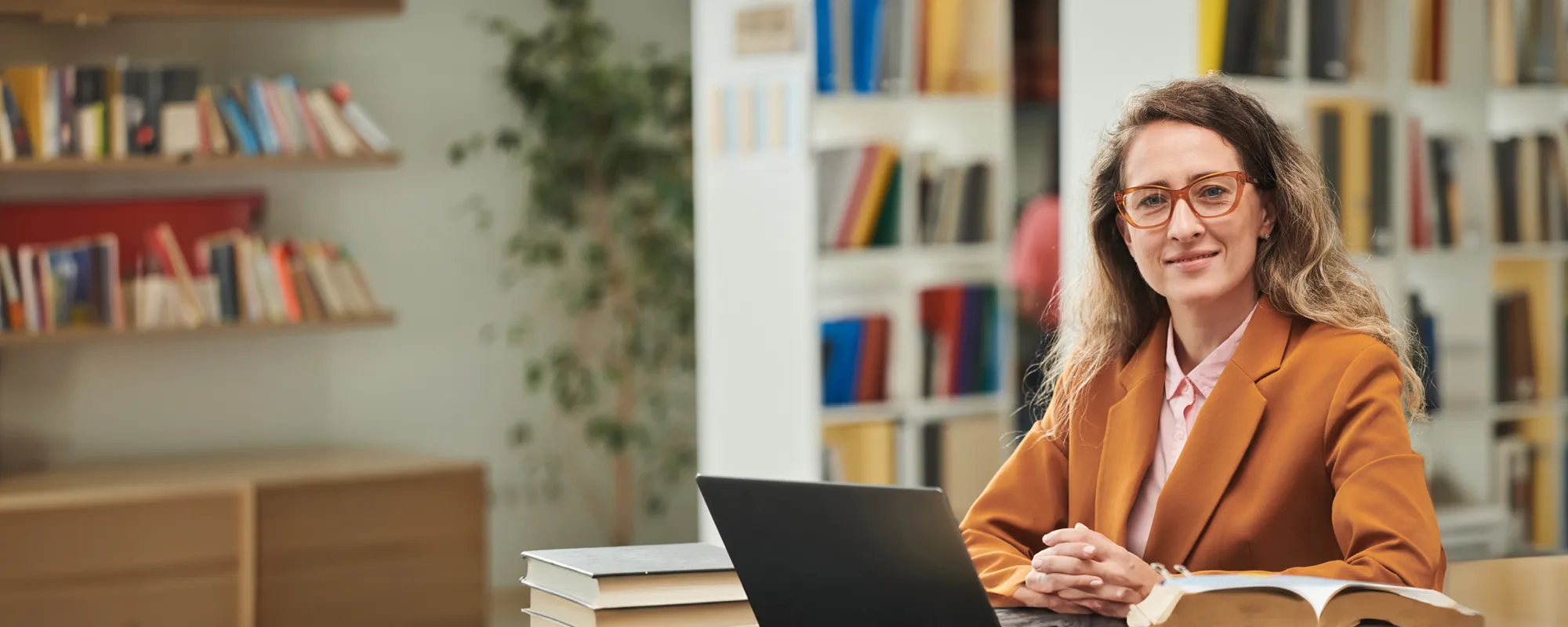 teacher-orange-suit-laptop-alt-shutterstock_2501727439