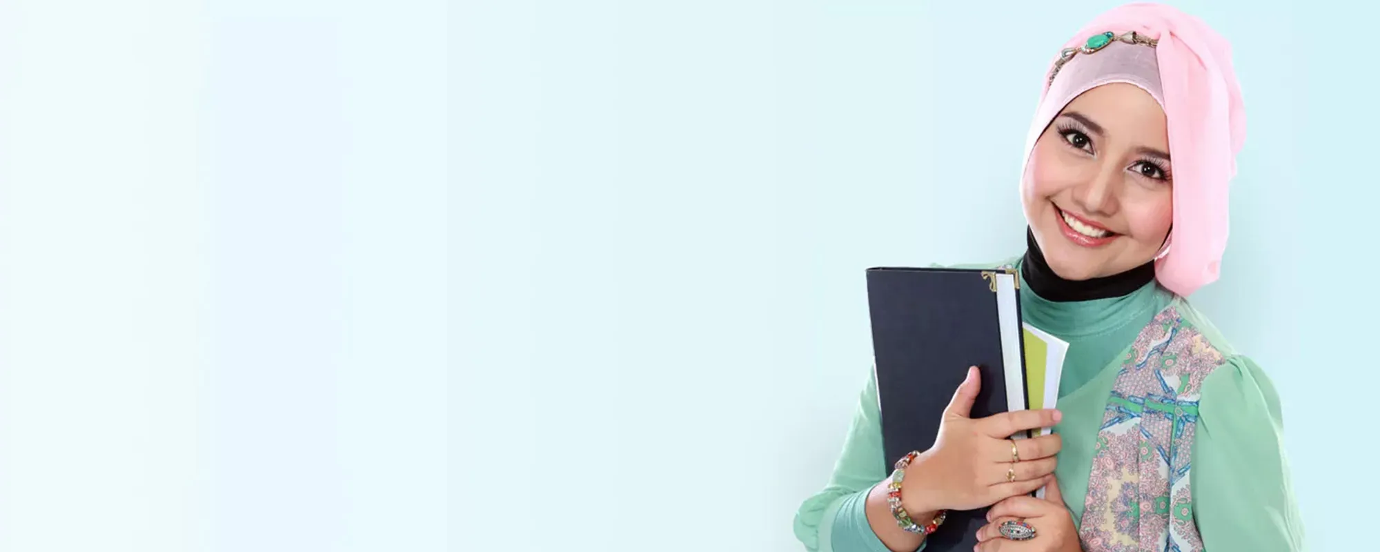 Female teacher wearing a headscarf and carry books