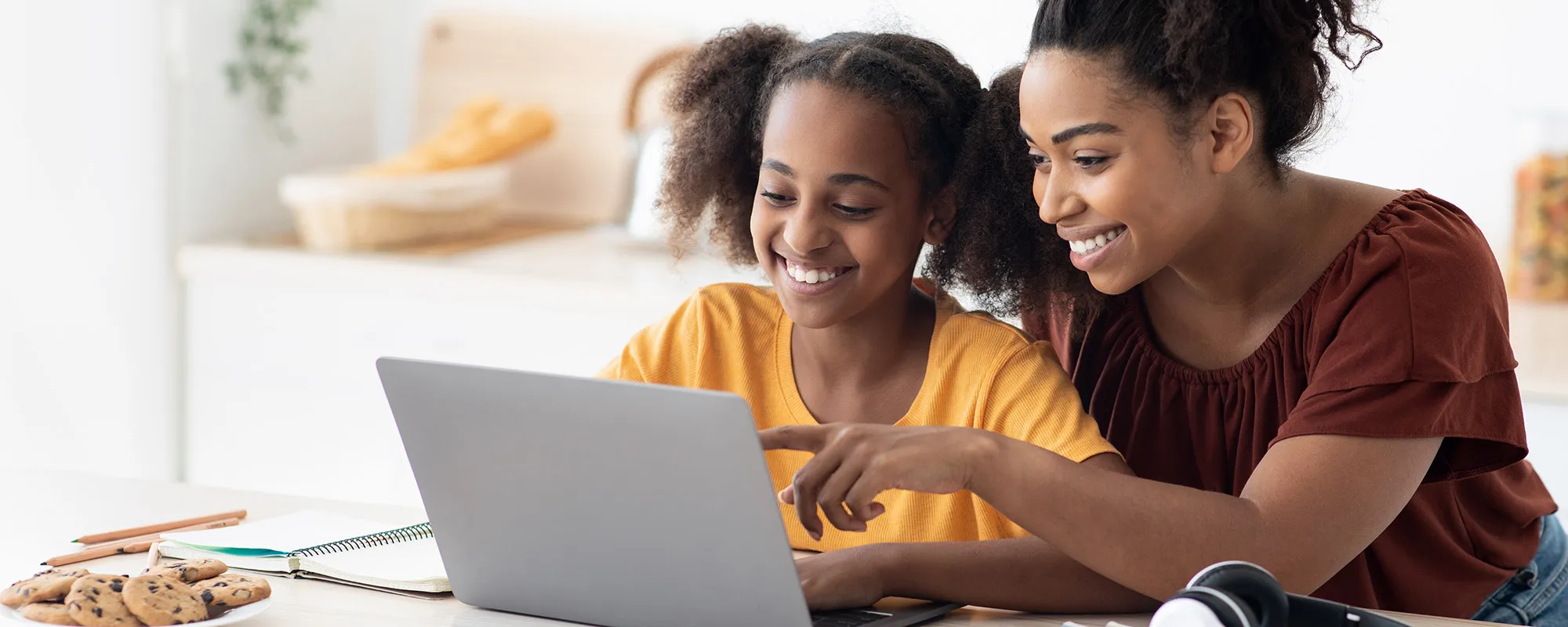 A woman and her child using Renaissance software on a laptop computer